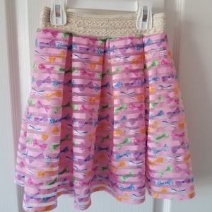 Girls pink skirt with multicolored bow pattern